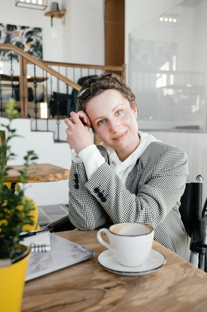 A cheerful woman in a café enjoying her coffee, creating a serene and positive atmosphere.